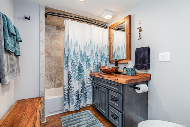 319 Old Trail Dr, Houghton Lake, MI 48629 - full bathroom featuring wood finished floors, shower / tub combo, and vanity