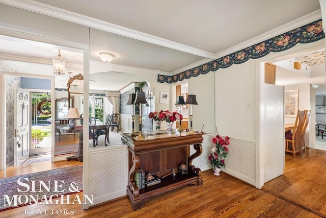 28 Hampton Rd, Grosse Pointe Shores, MI 48236 - living area featuring wood finished floors, crown molding, wainscoting, and a chandelier