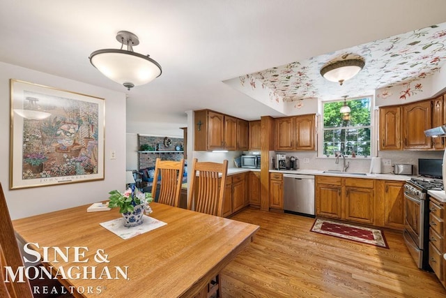 28 Hampton Rd, Grosse Pointe Shores, MI 48236 - kitchen featuring stainless steel appliances, brown cabinets, light countertops, and light wood-type flooring