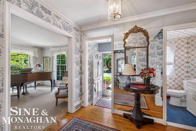 28 Hampton Rd, Grosse Pointe Shores, MI 48236 - entrance foyer featuring wallpapered walls, crown molding, and wood finished floors