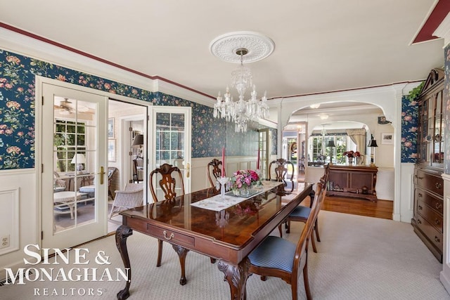 28 Hampton Rd, Grosse Pointe Shores, MI 48236 - dining room with wallpapered walls, a wainscoted wall, crown molding, a chandelier, and arched walkways