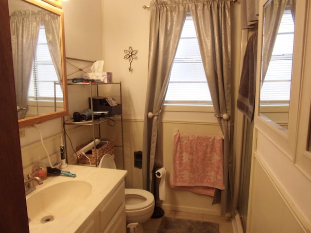 bathroom with tile patterned floors, vanity, and toilet