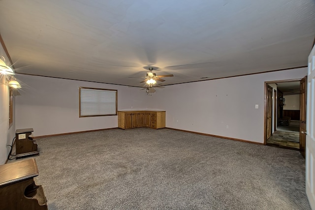 unfurnished living room featuring carpet flooring and ceiling fan