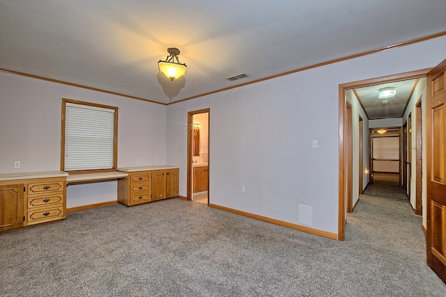 unfurnished bedroom featuring ensuite bath, crown molding, and light colored carpet