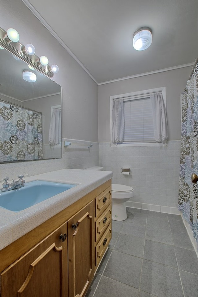 bathroom featuring tile patterned floors, vanity, tile walls, and ornamental molding