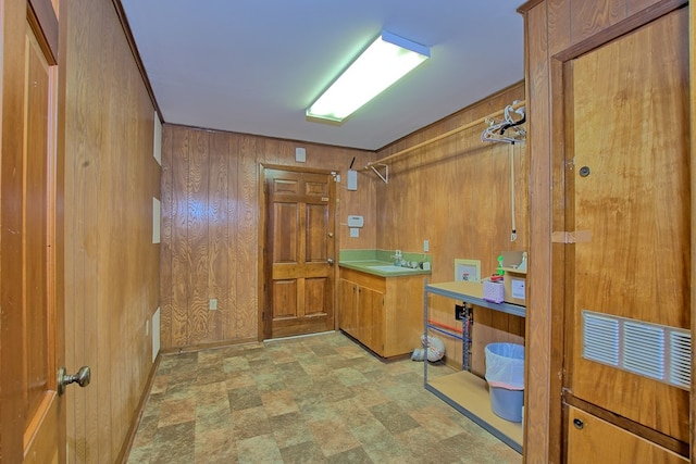 bathroom with vanity and wooden walls