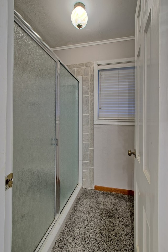 bathroom featuring an enclosed shower and crown molding