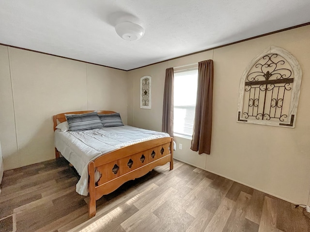 228 Blue Jay Dr, Brookeland, TX 75931 - bedroom with light wood-type flooring and ornamental molding