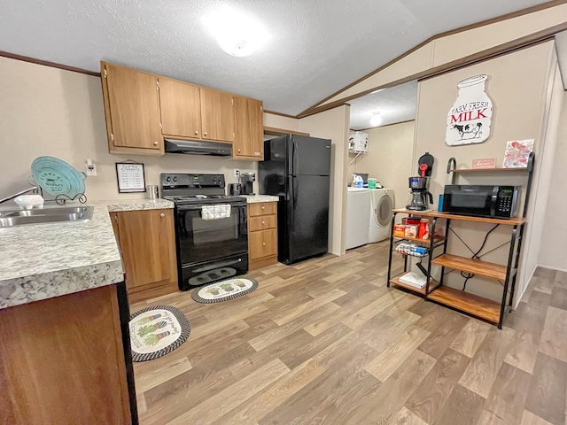 228 Blue Jay Dr, Brookeland, TX 75931 - kitchen with light countertops, light wood-type flooring, under cabinet range hood, a sink, and black appliances