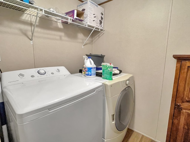 228 Blue Jay Dr, Brookeland, TX 75931 - washroom featuring light wood finished floors, washer and dryer, and laundry area
