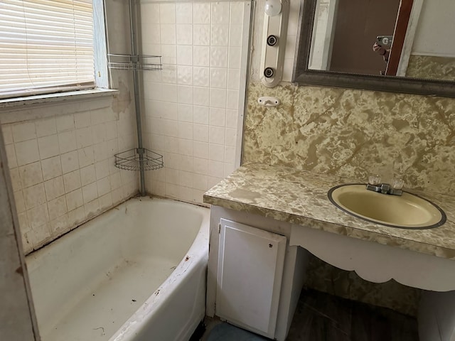 bathroom with vanity and a tub to relax in