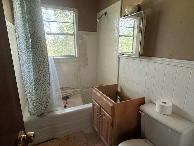 bathroom featuring shower / bath combination with curtain, tile walls, and toilet