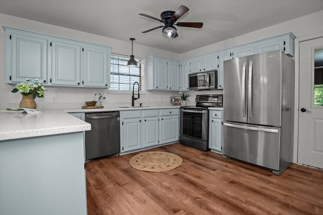 463 Allen Dr, Pollok, TX 75969 - kitchen with appliances with stainless steel finishes, ceiling fan, light countertops, dark wood finished floors, and decorative light fixtures