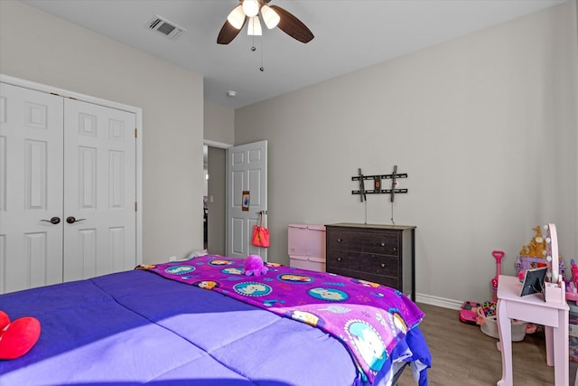 bedroom featuring wood-type flooring, a closet, and ceiling fan