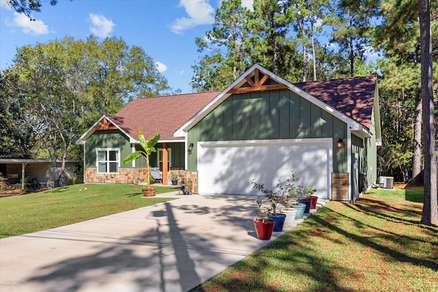 view of front of house featuring a front yard, a garage, and cooling unit