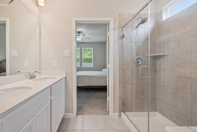 ensuite bathroom featuring tile patterned floors, a shower stall, a sink, and ensuite bath