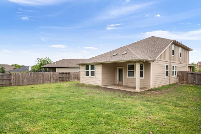 back of property featuring a lawn, a fenced backyard, and board and batten siding