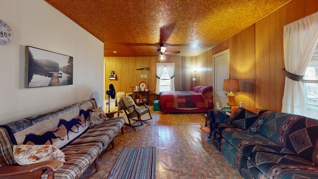 living room featuring wood walls and ceiling fan