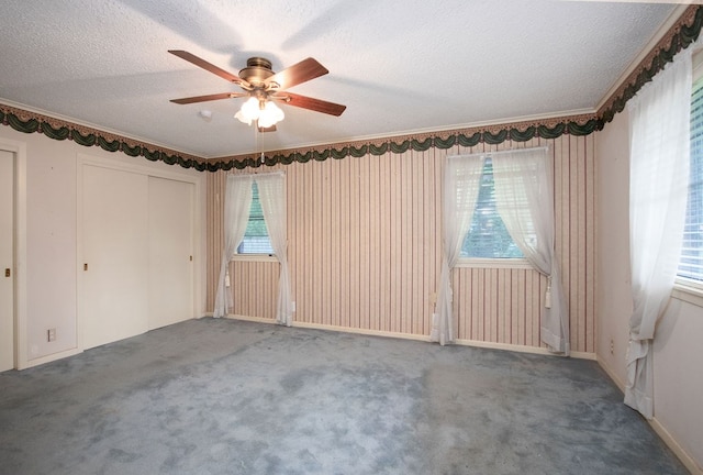 unfurnished room featuring carpet, a textured ceiling, and ceiling fan