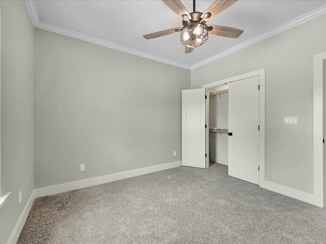 unfurnished bedroom with crown molding, a ceiling fan, a closet, carpet, and baseboards