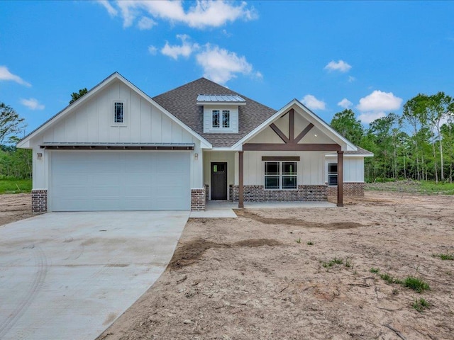 craftsman inspired home featuring concrete driveway, roof with shingles, board and batten siding, and a garage