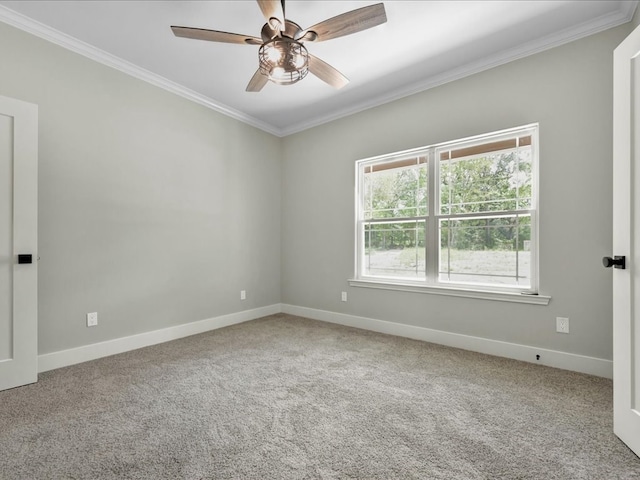 empty room featuring a ceiling fan, baseboards, ornamental molding, and carpet flooring