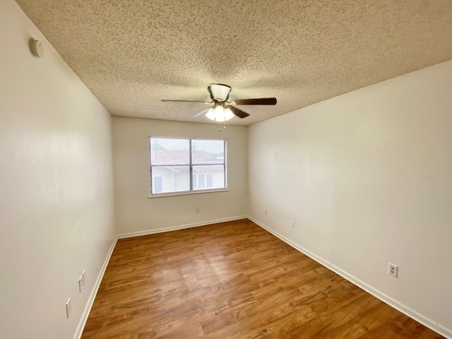 unfurnished room featuring ceiling fan, hardwood / wood-style floors, and a textured ceiling