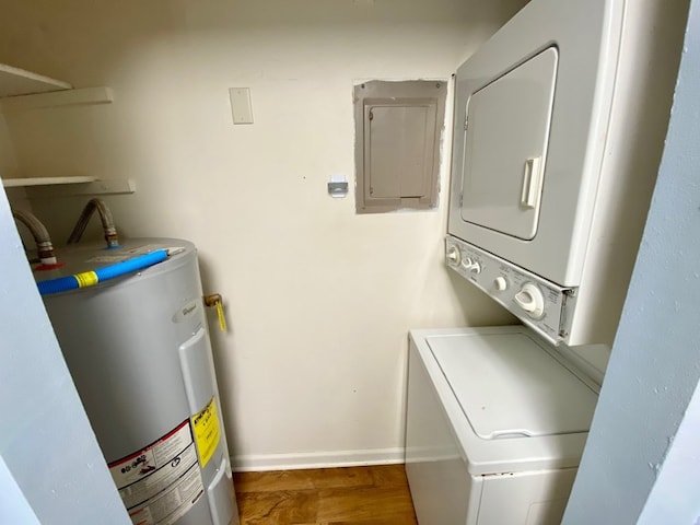 laundry room featuring electric water heater, stacked washer / dryer, electric panel, and dark wood-type flooring