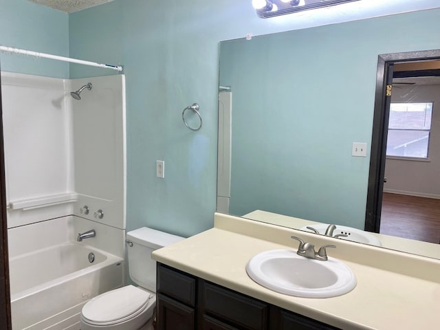 full bathroom with vanity, a textured ceiling, shower / washtub combination, wood-type flooring, and toilet