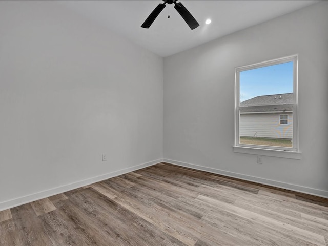 spare room with light hardwood / wood-style floors and ceiling fan