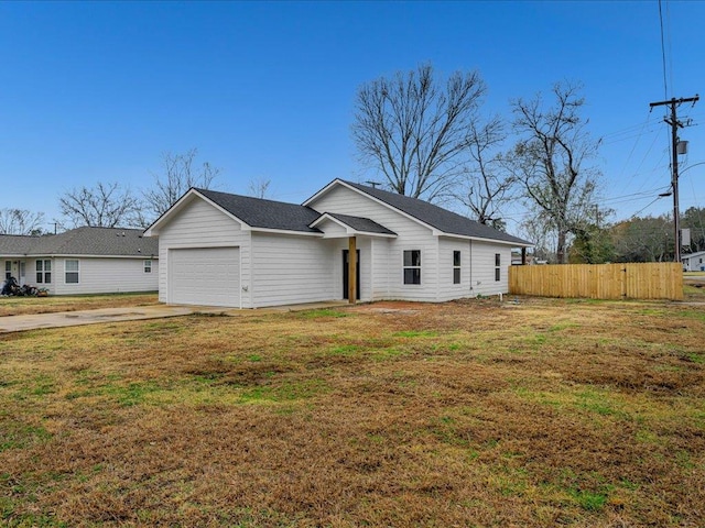 single story home featuring a garage and a front lawn