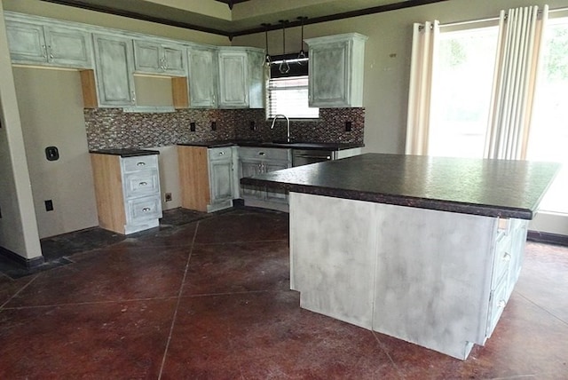 kitchen featuring backsplash, a wealth of natural light, a kitchen island, and dark tile patterned flooring