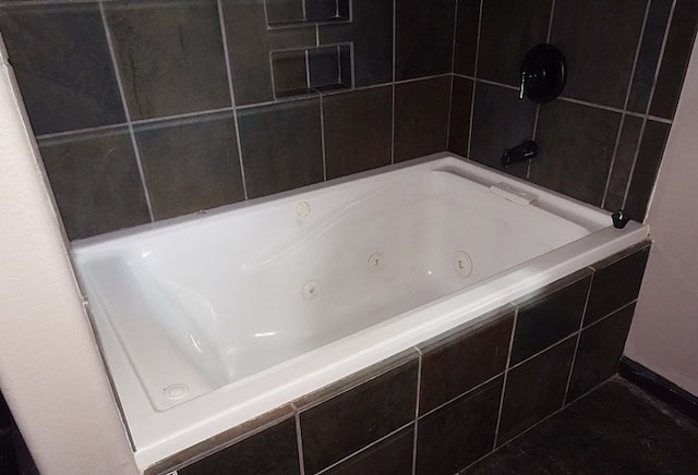 bathroom with tiled tub