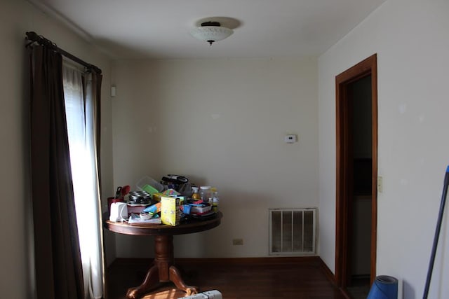 dining area with visible vents, baseboards, and wood finished floors