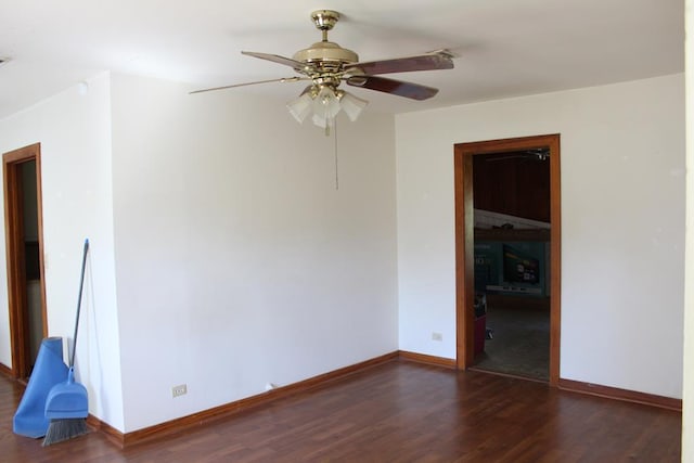 spare room featuring ceiling fan, baseboards, and wood finished floors