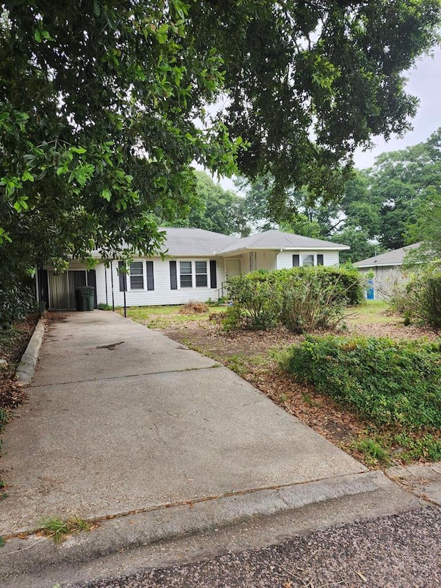 ranch-style home with driveway and a carport