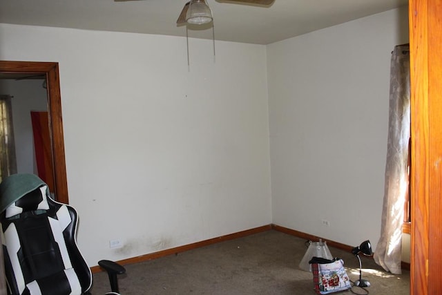 empty room with carpet floors, ceiling fan, and baseboards