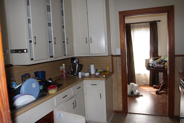 kitchen featuring light floors, white cabinets, and light countertops