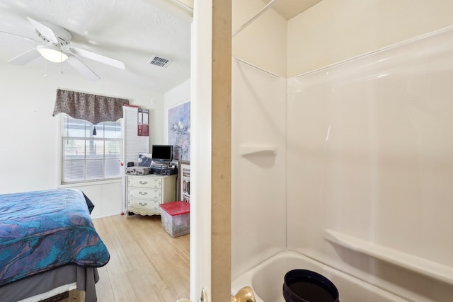 full bath with a ceiling fan, visible vents, shower / washtub combination, and wood finished floors