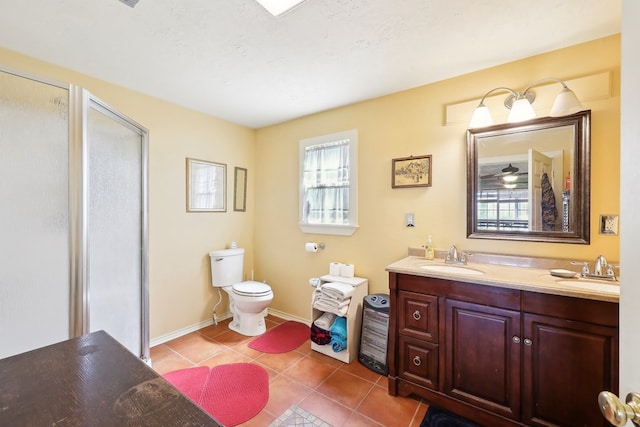 bathroom featuring toilet, tile patterned flooring, a sink, and a shower stall