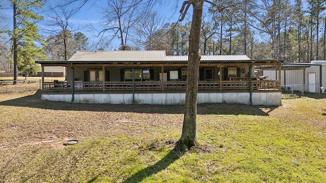 back of house featuring a carport and metal roof