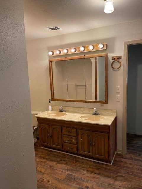 bathroom featuring hardwood / wood-style flooring, vanity, and toilet