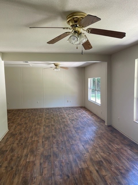 empty room featuring dark hardwood / wood-style flooring and a textured ceiling