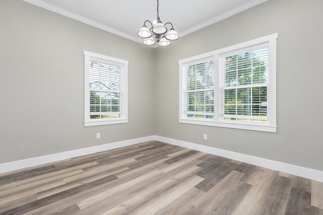 121 Kerr Ave, Lufkin, TX 75904 - spare room featuring crown molding, a chandelier, wood finished floors, and baseboards