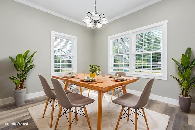 121 Kerr Ave, Lufkin, TX 75904 - dining space with baseboards, crown molding, light wood-style flooring, and a chandelier