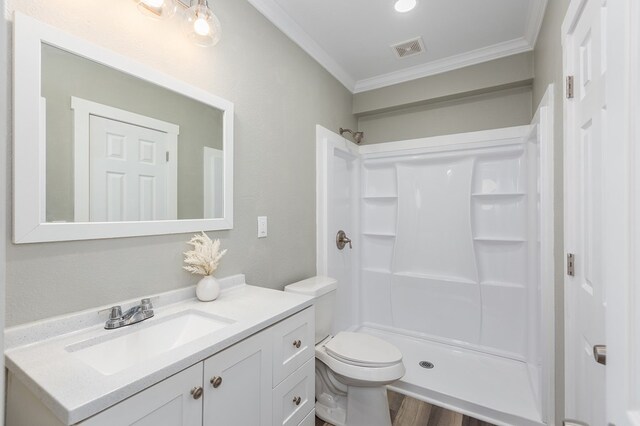 121 Kerr Ave, Lufkin, TX 75904 - full bathroom with crown molding, vanity, a shower, toilet, and wood finished floors