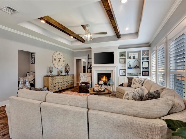 living room with ceiling fan, dark hardwood / wood-style flooring, beamed ceiling, and ornamental molding