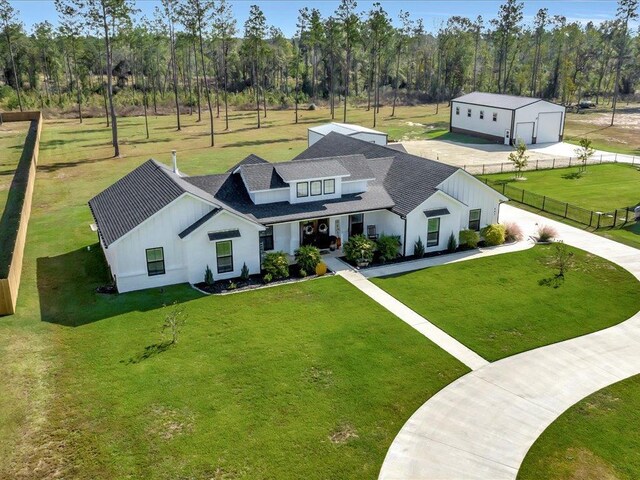 view of front of property featuring covered porch and a front yard