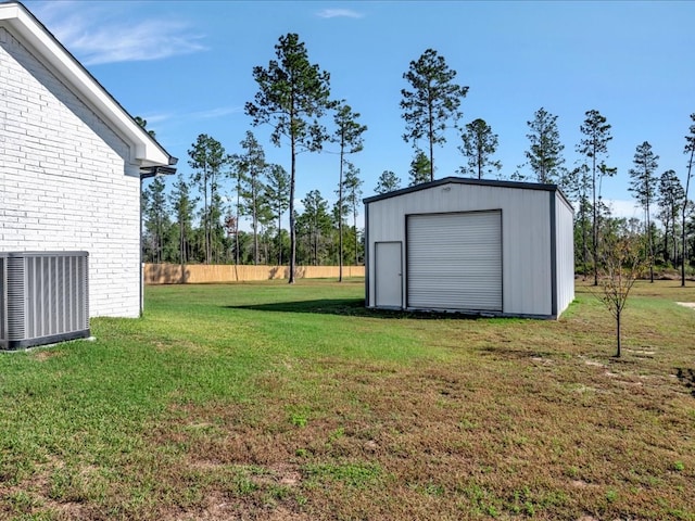 view of yard with central AC and a storage shed