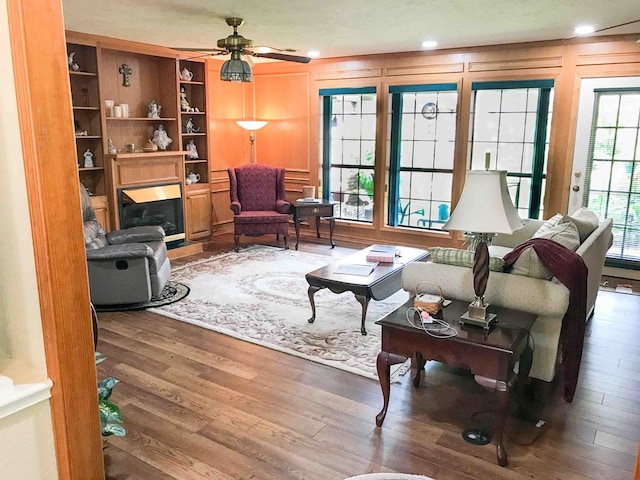 living room with hardwood / wood-style flooring and ceiling fan